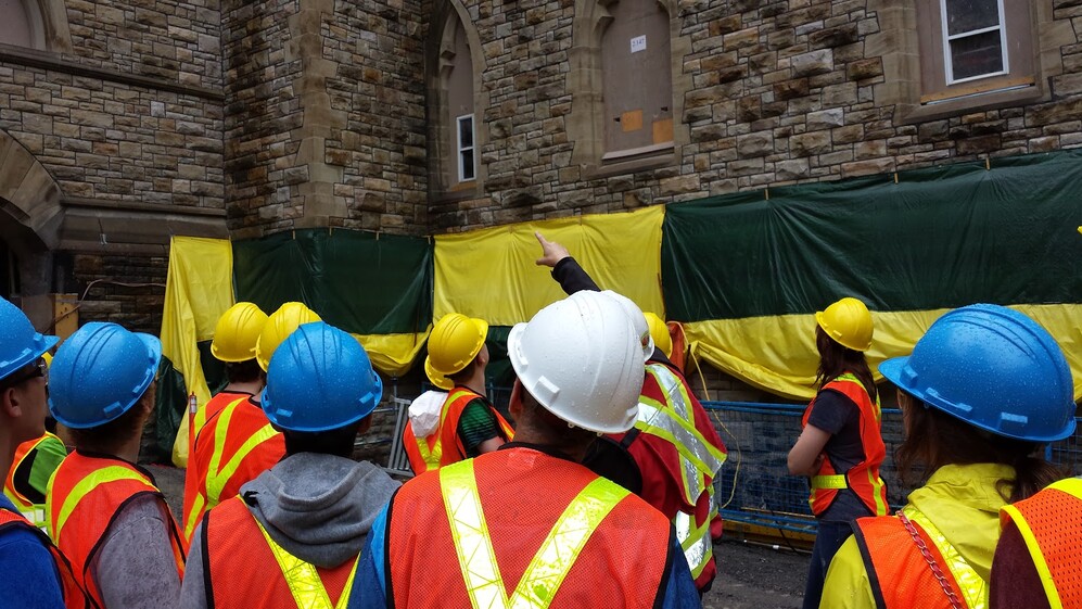 Group of students in hard hats and safety jackets