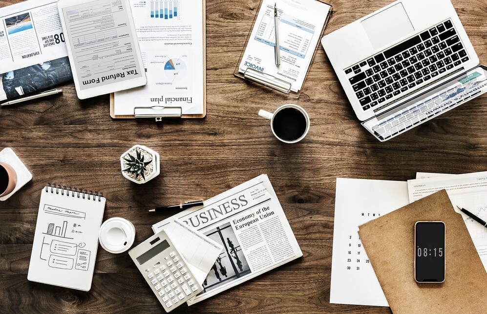 desk with comjputer and papers