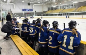 girls hockey team at the bench